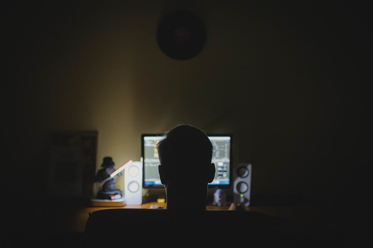 Man doing research on computer at night